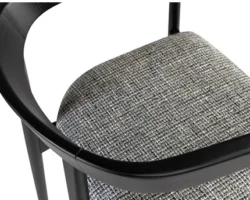 Modern black chair with textured gray seat fabric and curved armrest. Maison Mermont.
