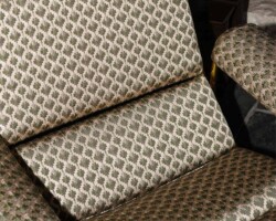 Patterned armchair with houndstooth upholstery in neutral tones. Maison Mermont.