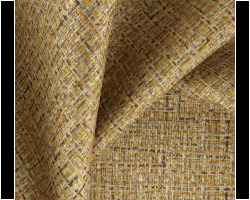 Luxurious textured gold fabric with a woven pattern, ideal for home furnishings. Maison Mermont.