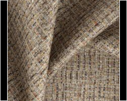 Textured beige woven upholstery fabric displaying subtle multi-color specks. Maison Mermont.