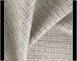 Textured beige woven fabric for upholstery or curtains, ideal for elegant home decor. Maison Mermont.