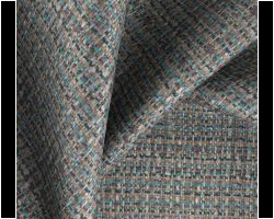 Textured tweed fabric in teal and gray tones for upholstery or curtains. Maison Mermont.