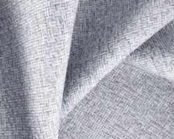 Textured light grey woven fabric, ideal for upholstery or curtains. Maison Mermont.