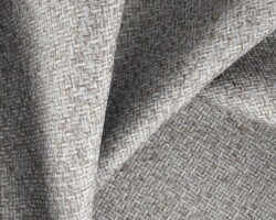 Woven textured fabric in neutral tones, ideal for upholstery or curtains. Maison Mermont.