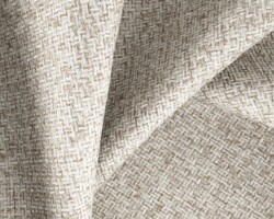 Elegant textured beige fabric for upholstery or drapery. Maison Mermont.