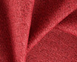 Red textured fabric with a woven pattern, ideal for home decor upholstery. Maison Mermont.