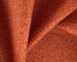 Burnt orange woven textile fabric with a textured pattern for upholstery. Maison Mermont.