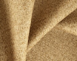 Textured beige woven fabric showcasing intricate pattern, perfect for home décor. Maison Mermont.