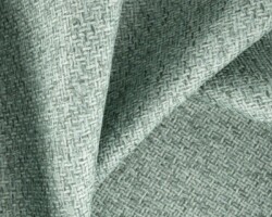 Soft, textured green fabric showcasing intricate weave details. Suitable for home furnishings. Maison Mermont.