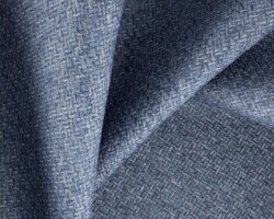 Blue woven fabric texture for home furnishings, showcasing intricate detailing. Maison Mermont.