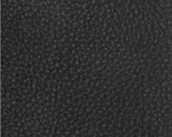 Close-up of textured black leather upholstery fabric. Maison Mermont.
