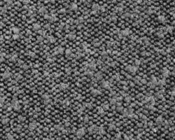 Gray textured wool carpet detail, ideal for cozy home interiors. Maison Mermont.
