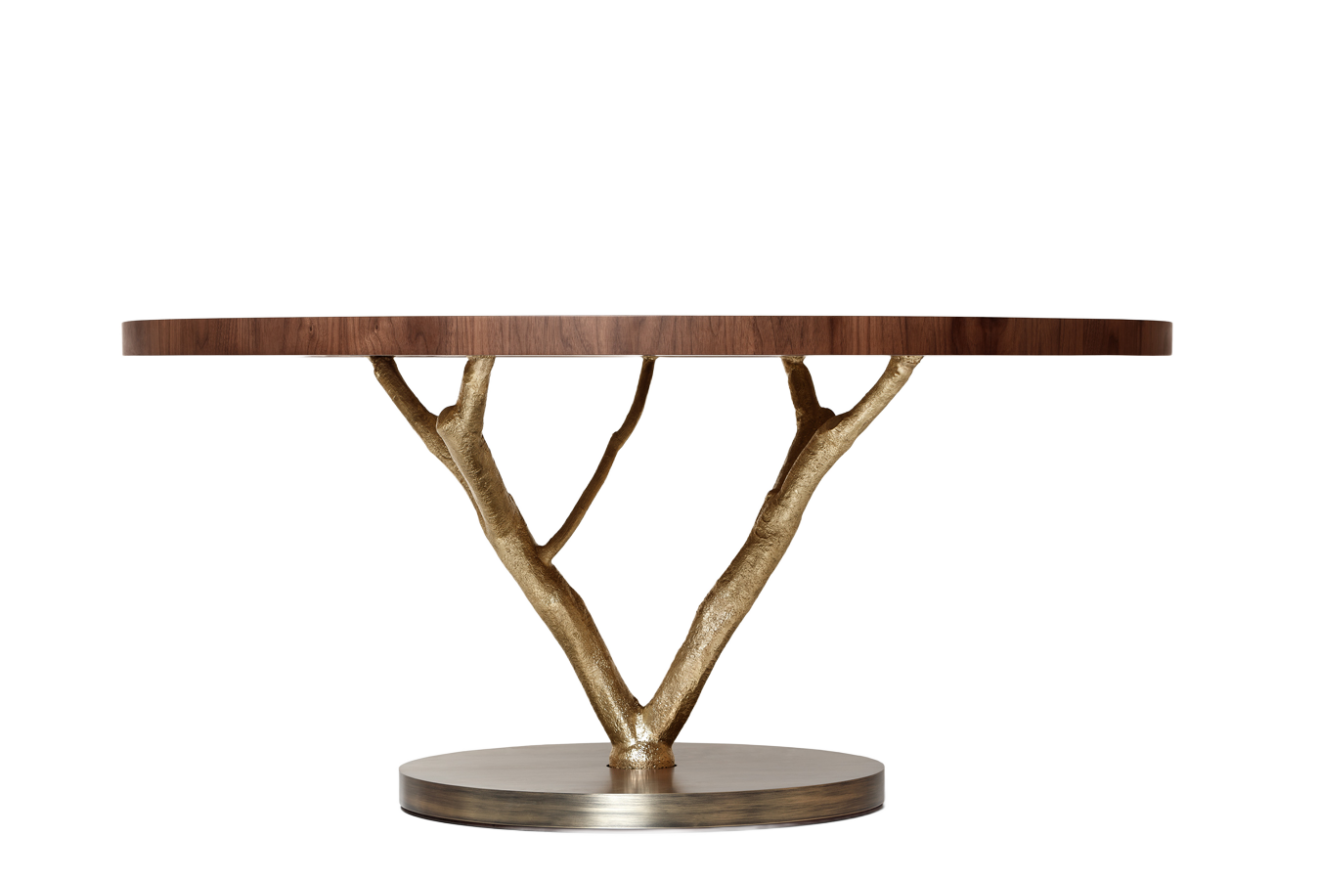 Elegant round wooden table with a unique gold branch base, combining modern design with natural elements. Maison Mermont.