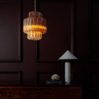 Amber-Small-Celesta-Chandelier Elegant crystal pendant light illuminating a dark wood room setting. Maison Mermont.