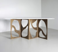 Elegant console table with artistic bronze base, featuring sculptural design and marble top. Maison Mermont.