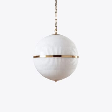 Modern white globe pendant light with a gold accent, perfect for stylish home decor. Maison Mermont.