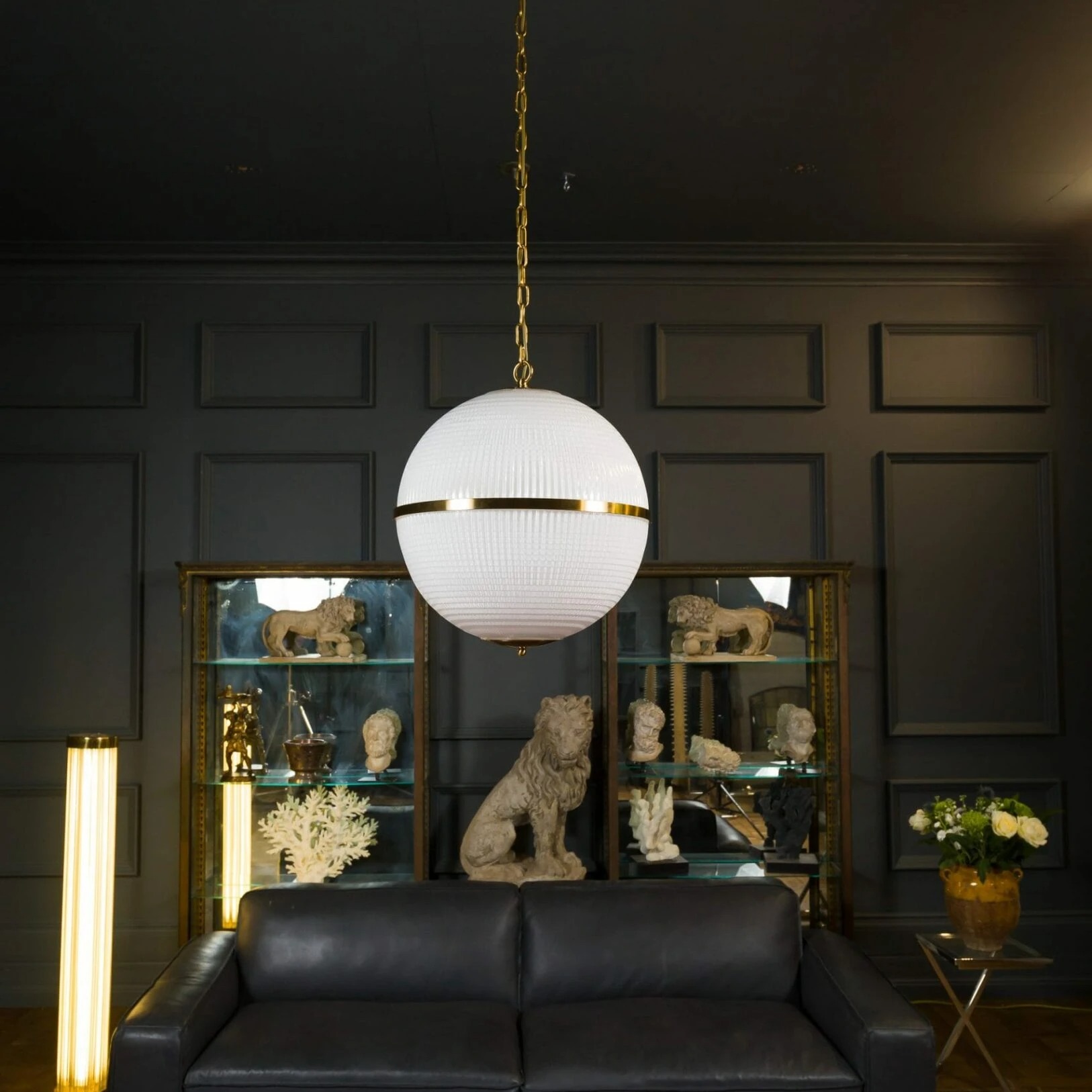 Large Opaline Parisian Globe Pendant_7269-1626x1626 Elegant white globe pendant light with gold accents, illuminating a stylish interior. Maison Mermont.