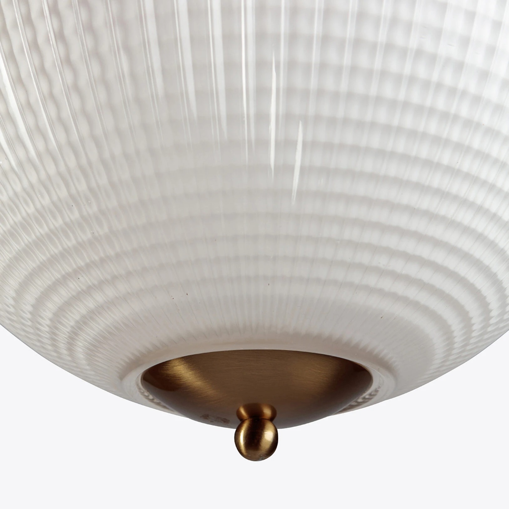Opaline Parisian Globe Pendant-5855-1626x1626 Elegant round glass pendant light with a ribbed texture and brass accent. Perfect for modern interiors. Maison Mermont.