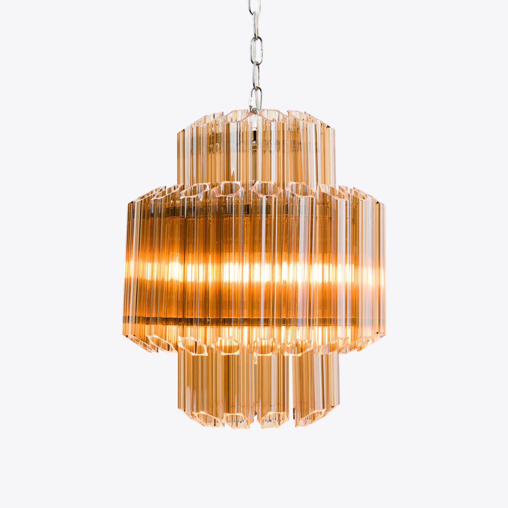 Amber-Small-Celesta-Chandelier Elegant amber glass chandelier with a modern design, creating a warm ambient glow. Maison Mermont.