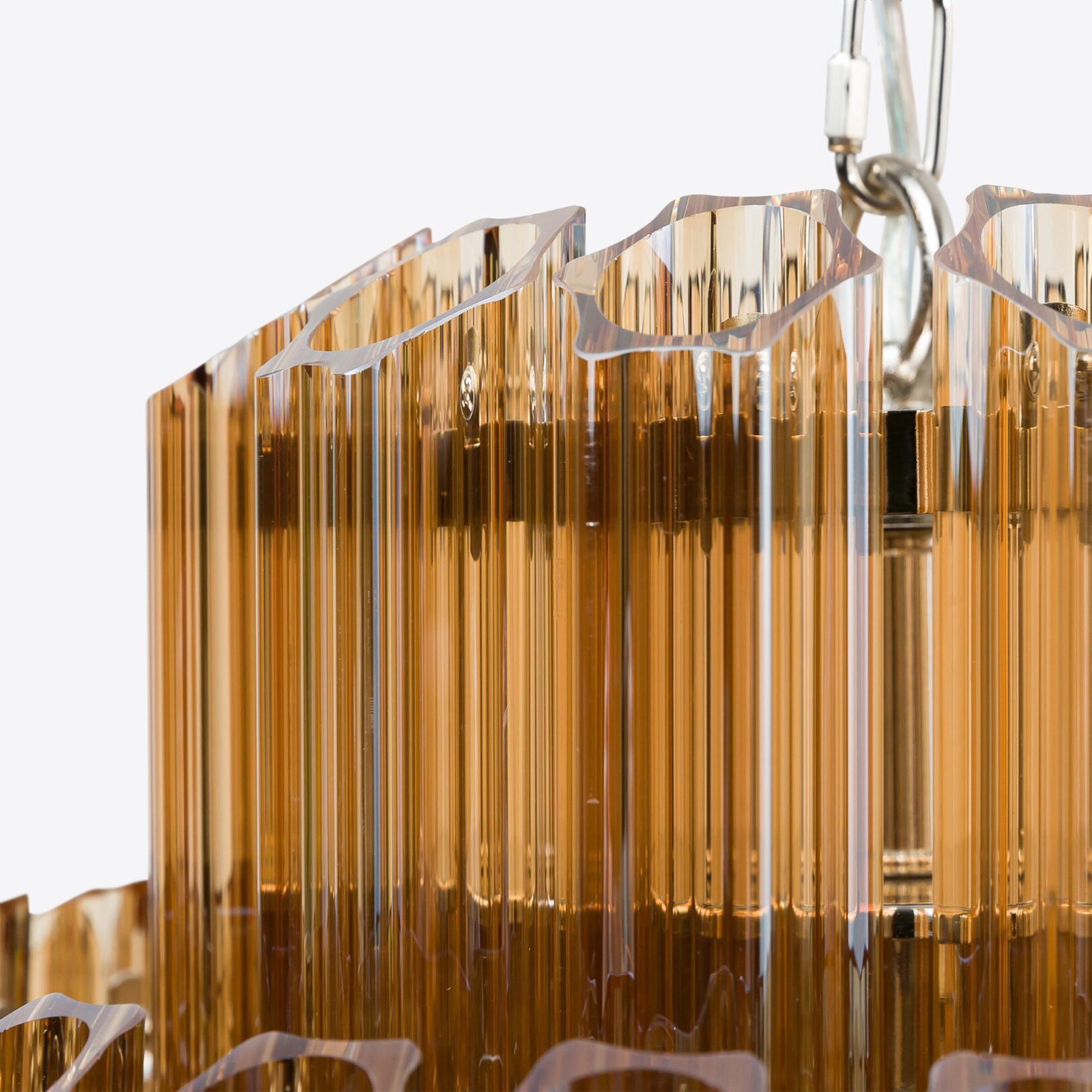 Amber-Small-Celesta-Chandelier Luxurious amber glass chandelier detail with elegant vertical lines. Maison Mermont.
