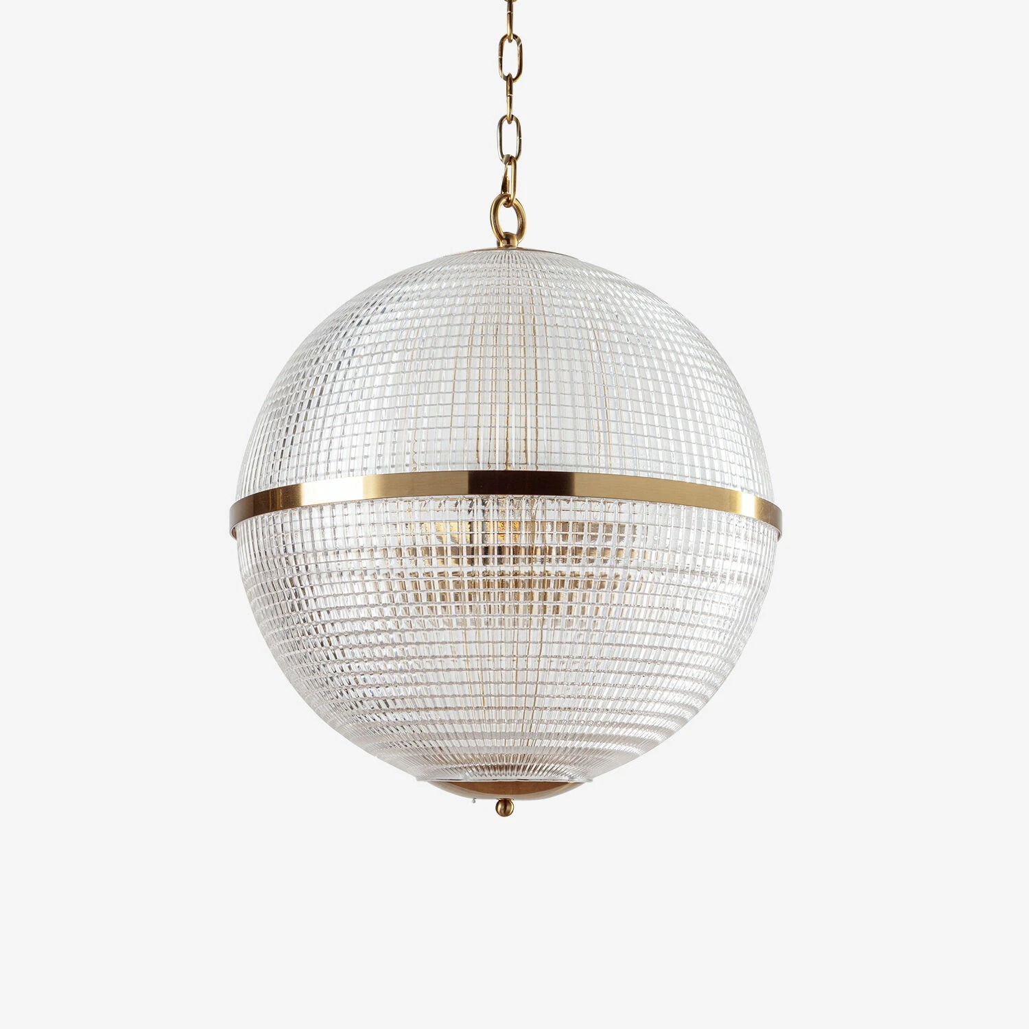 Stylish round pendant light with a textured glass design and gold accents, perfect for modern interiors. Maison Mermont.