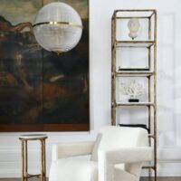 Large Clear Parisian Globe Pendant Modern living room featuring a stylish globe pendant light, elegant shelving unit, and cozy textured armchair. Maison Mermont.