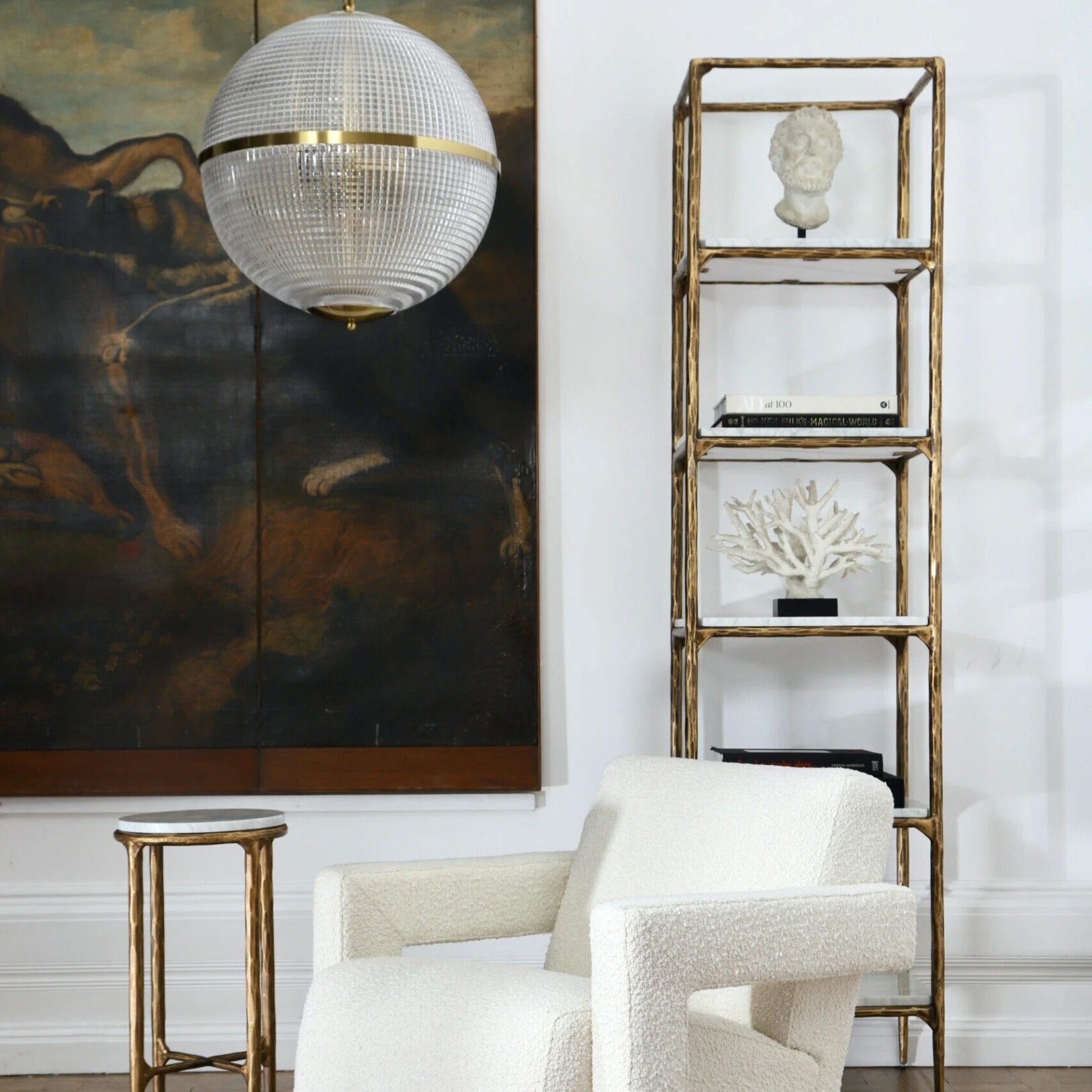 Large Clear Parisian Globe Pendant Modern living room featuring a stylish globe pendant light, elegant shelving unit, and cozy textured armchair. Maison Mermont.