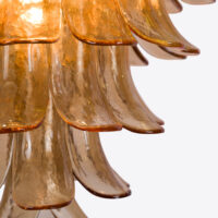 Amber Corolla Large Chandelier Elegant amber glass pendant lamp featuring cascading leaf-like shapes for a warm glow. Maison Mermont.