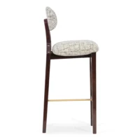 maison-mermont-silhouette-bar-stool-mix-02-translucent-dark-brown-oxidized-brushed-brass-03-insidherland Elegant upholstered bar stool with a curved backrest and wooden legs, perfect for modern interiors. Maison Mermont.
