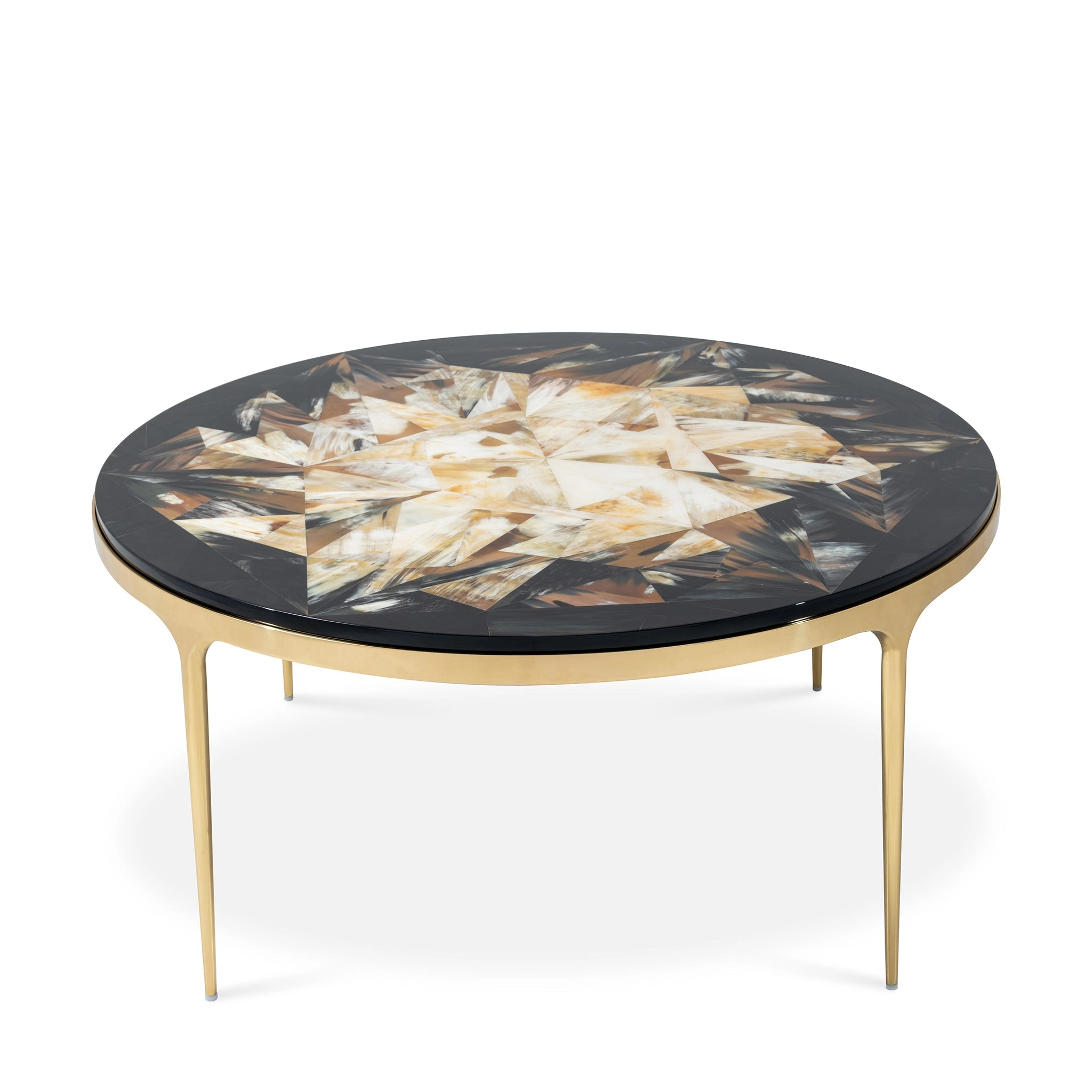 Elegant round coffee table with a patterned top and gold legs, perfect for modern interiors. Maison Mermont.