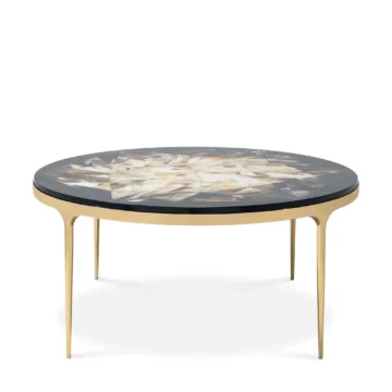 Elegant round coffee table with a unique inlaid top and gold legs, perfect for modern living spaces. Maison Mermont.