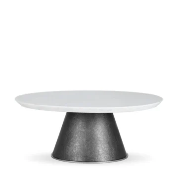 Modern round coffee table with a sleek white marble top and textured black base, perfect for contemporary living spaces. Maison Mermont.