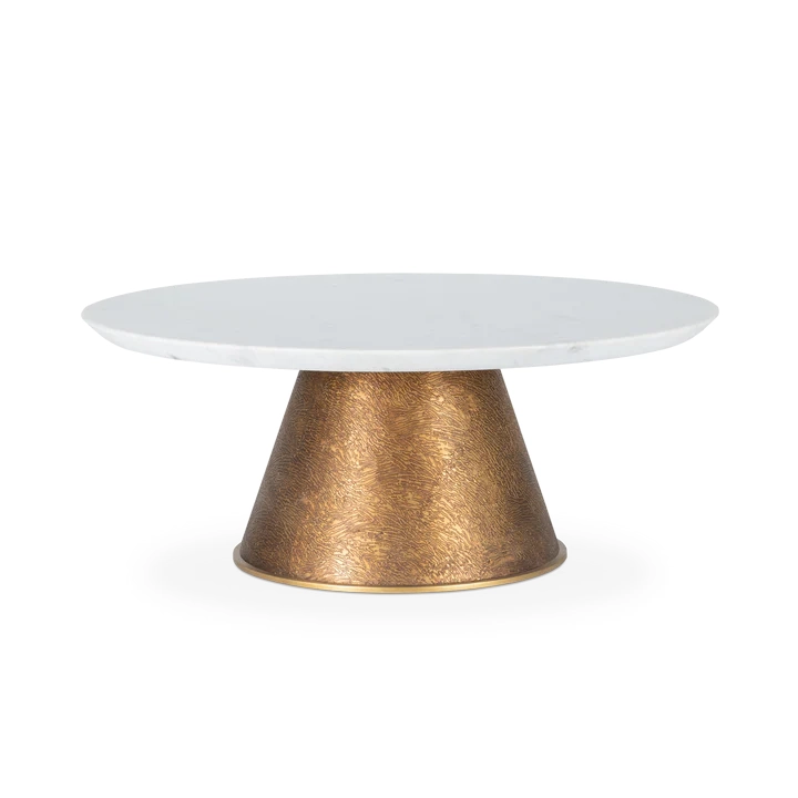 Elegant white marble top coffee table with a textured brass base, perfect for modern living spaces. Maison Mermont.