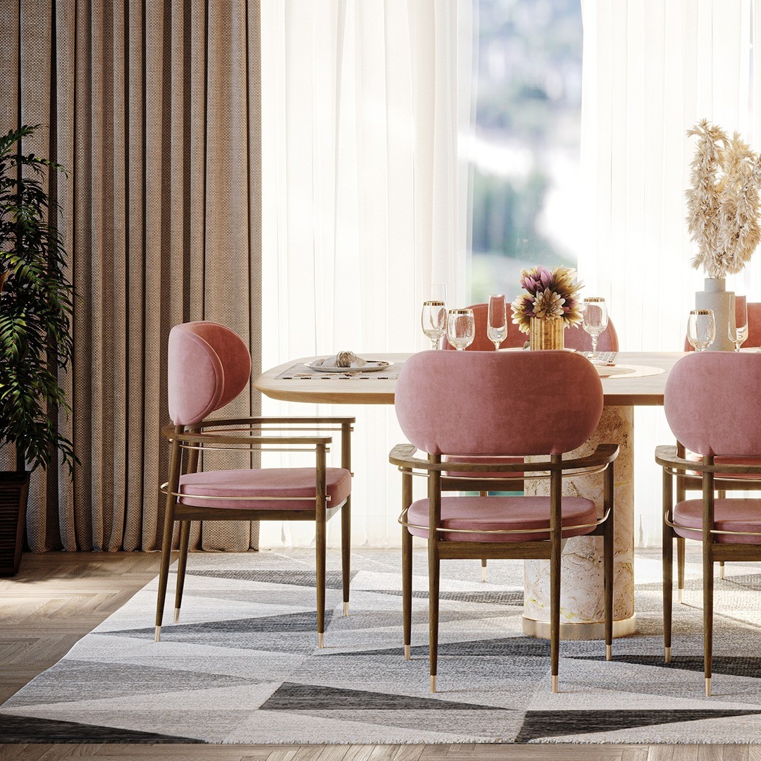 Elegant dining room featuring pink velvet chairs around a modern round table with floral decor. Maison Mermont.