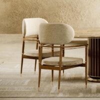 Elegant beige dining chairs with curved backs, perfect for modern interiors. Stylish and comfortable seating by Maison Mermont.