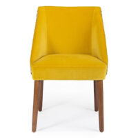 Bright yellow velvet chair with wooden legs, perfect for modern decor. Stylish and comfortable seating option. Maison Mermont.