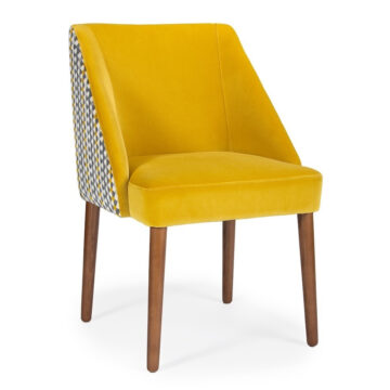 Stylish yellow velvet chair with patterned backrest and wooden legs, perfect for modern interiors. Maison Mermont.