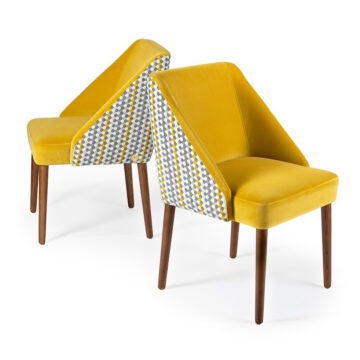 Stylish yellow upholstered chairs with geometric patterned backs, perfect for modern interiors. Maison Mermont.