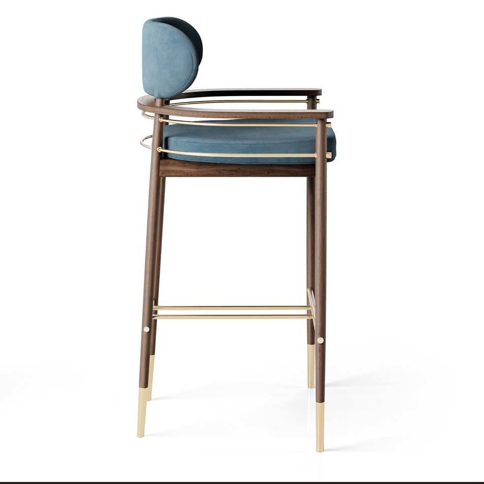 maison_mermont_hopper_bar_chair1 Elegant wooden bar stool with a soft blue cushion and gold accents, perfect for modern interiors. Maison Mermont.