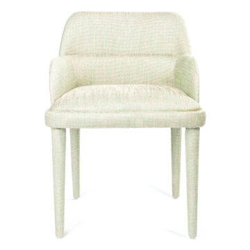 Stylish light green upholstered dining chair with rounded back and sleek legs. Perfect for modern interiors. Maison Mermont.