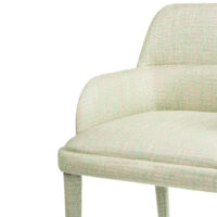 Light green upholstered chair with a modern design and curved backrest, perfect for stylish interiors. Maison Mermont.
