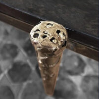 Roma Coffee Table Detail Handcrafted metal coffee table with bronze textured legs, showcasing modern artisanal design. Maison Mermont