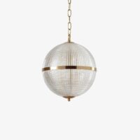 Elegant round pendant light with a gold finish and crystal detailing, perfect for modern interiors. Maison Mermont.