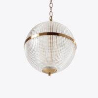 Elegant glass globe pendant light with brass accents, perfect for modern interiors. Maison Mermont.