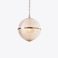 Elegant globe pendant light with a textured glass shade and gold accents, perfect for modern decor. Maison Mermont.