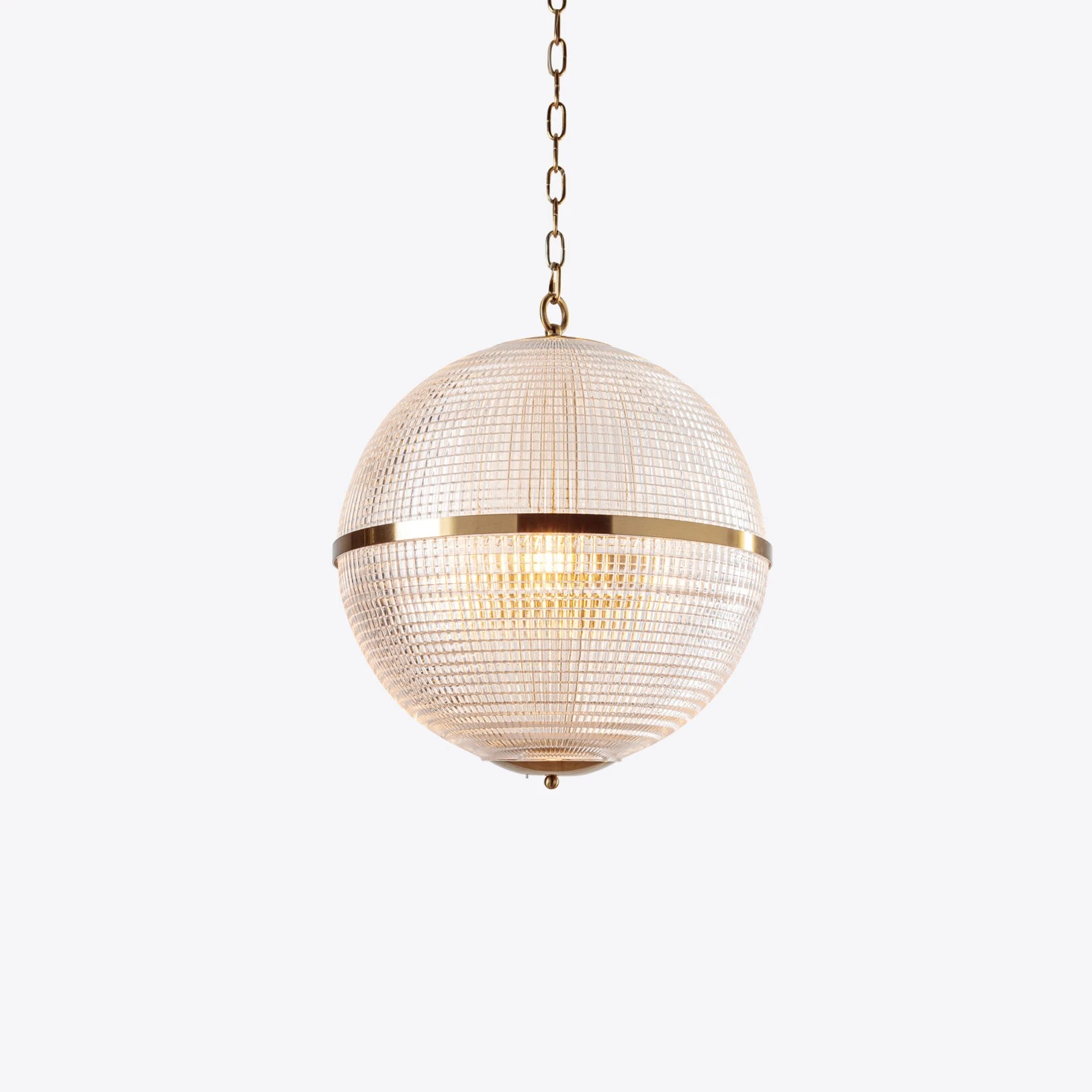 Elegant globe pendant light with a textured glass shade and gold accents, perfect for modern decor. Maison Mermont.