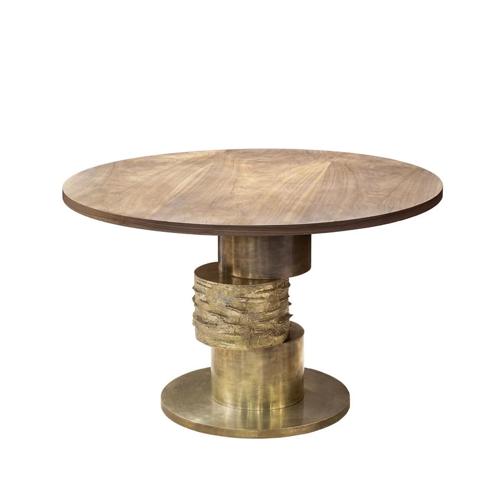 Round table with textured bronze base and custom top, showcasing luxury design. Maison Mermont.
